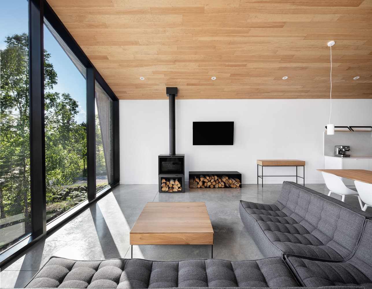 Living room with wood fireplace, Le Littoral, Cap-à-l'Aigle