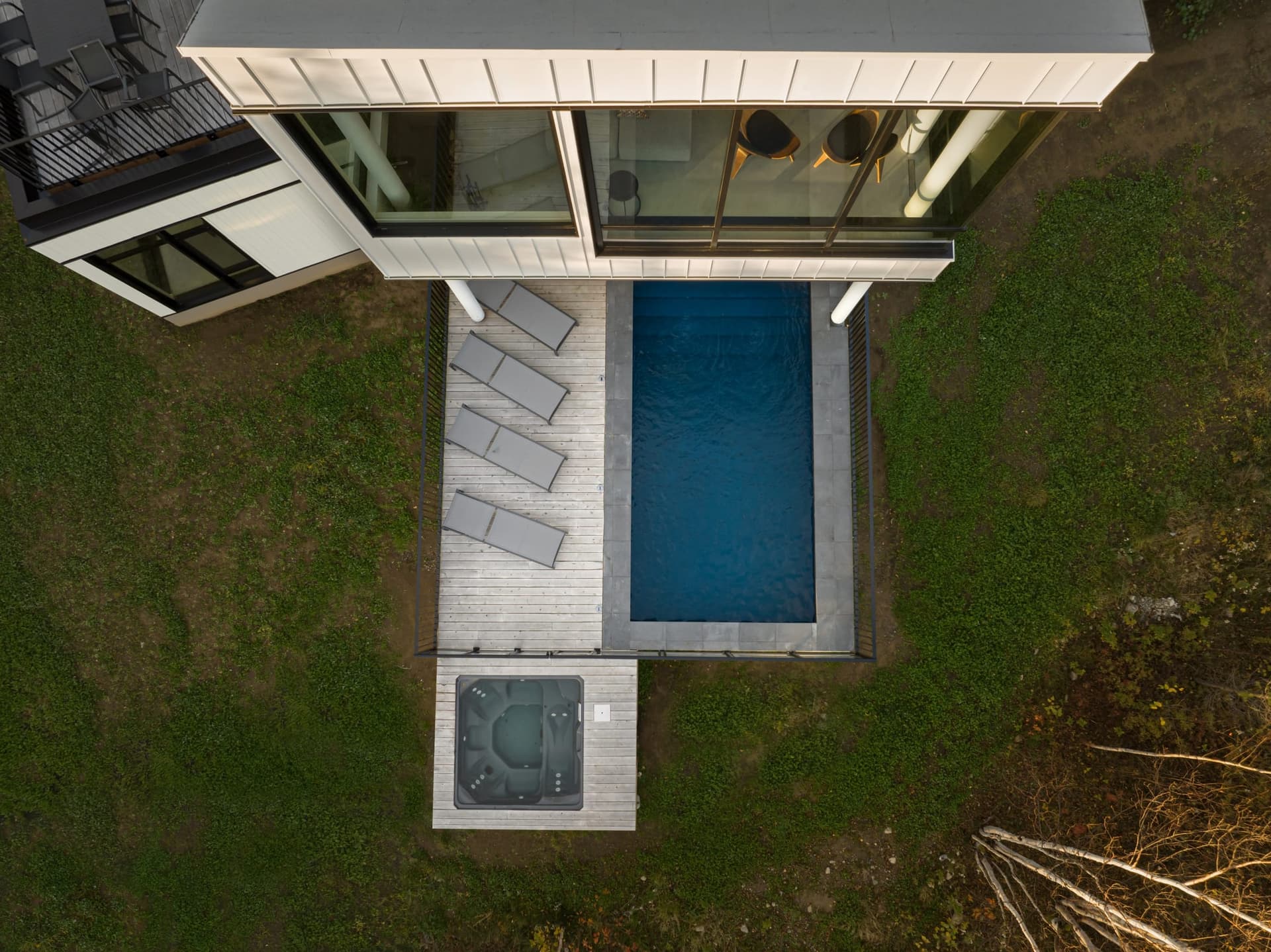 Aerial view of L'Embâcle outdoor pool in the clearing, Cap-à-l'Aigle