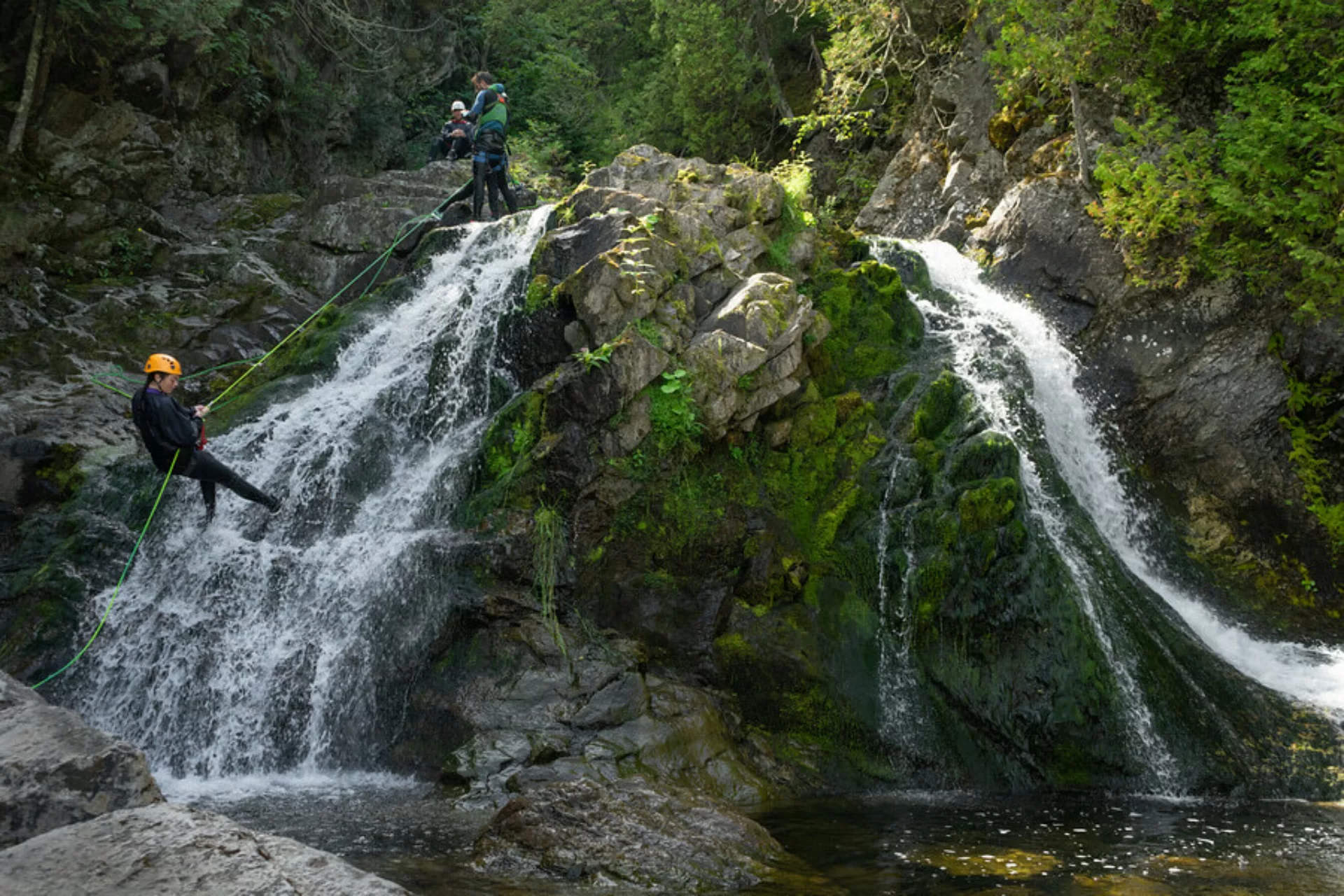 Canyoning participant rappelling down a waterfall