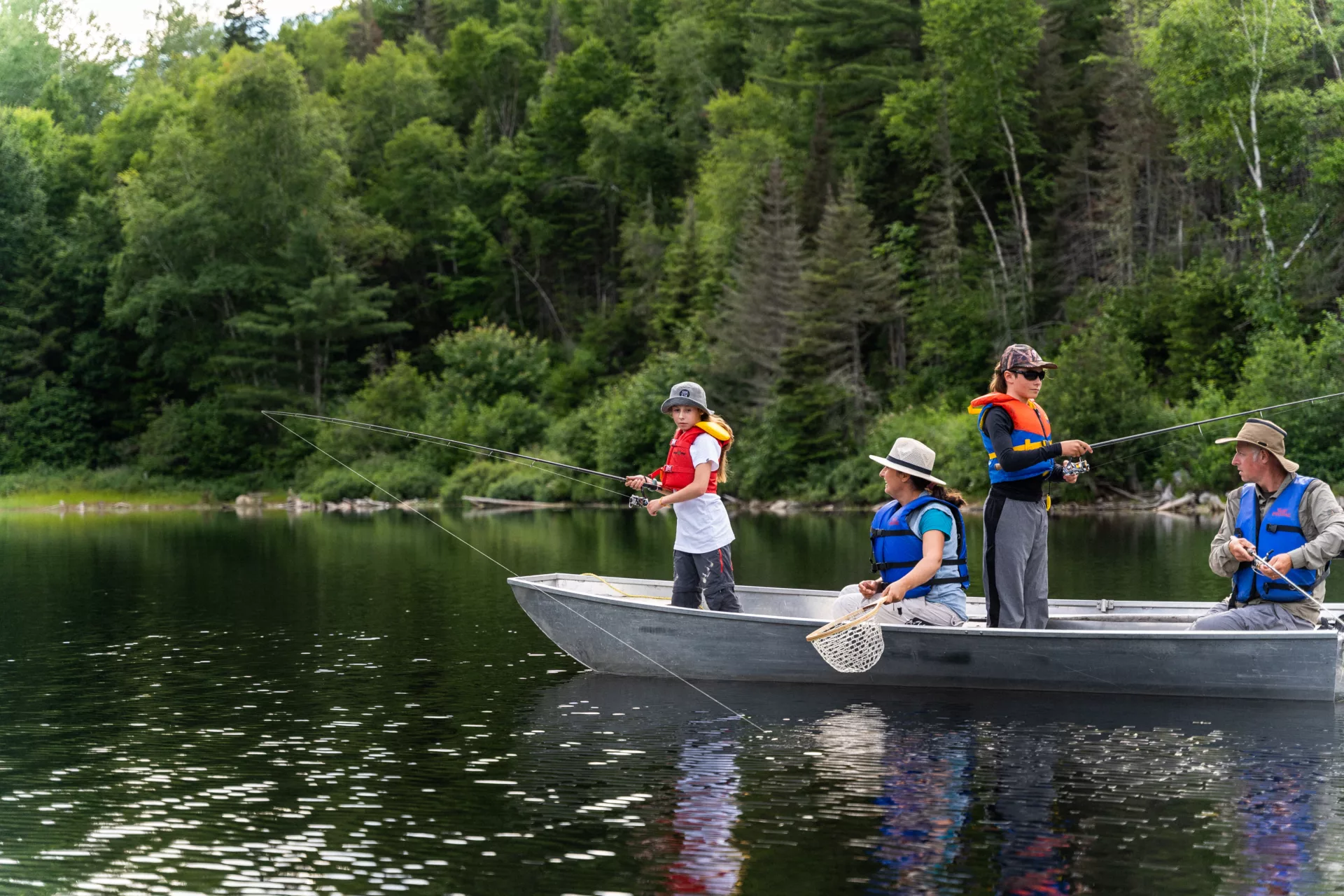 Family fishing from a rowboat on an outfitter's lake in Charlevoix