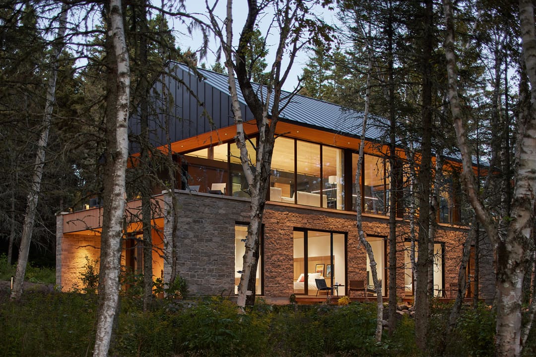 Villa Luce at dusk among the trees, La Malbaie, Charlevoix